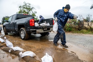 Atmospheric river hits Southern California with risks of flash floods and deaths on stormy seas
